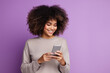 woman with phone on purple background . .