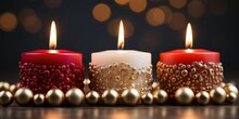 Three Lit Candles Sitting Next To Christmas Ornaments. Christmas Decoration. A Glowing Candle Centerpiece.