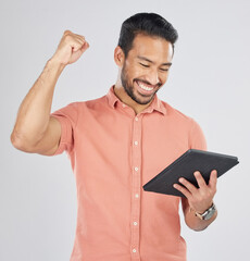 Canvas Print - Happy asian man, tablet and fist pump in winning, celebration or promotion against a white studio background. Excited male person with technology app in happiness for victory, success or good news