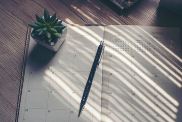 Wall Mural - agenda, planner book, calendar, pencil, and cactus place on business office desk. diary for organize