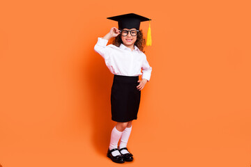 Wall Mural - Photo of little smart schoolgirl professor graduate school wear mortarboard hat isolated bright color background