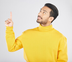 Poster - Announcement, thinking and man pointing for promotion, deal and logo isolated in a studio white background with smile. Choice, offer and happy person or ambassador showing advertising or news
