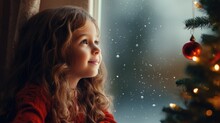 A Little Girl Looking Out A Window At A Christmas Tree
