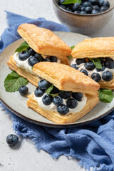 Wall Mural - Stuffed puff cookies with whipped cream and blueberries