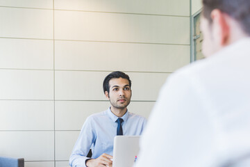 multiethnic businessman young working indoors