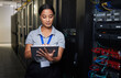 © Nina L/peopleimages.com - Woman, tablet and server room in inspection, programming and coding with system solution and cybersecurity. Engineering person on digital tech, hardware maintenance or business network in data center