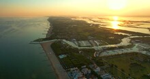 Italy, Jesolo. Lido Di Jesolo, Or Jesolo Lido, Europe Beach And City Area Of City Of Jesolo In The Province Of Venice, Aerial Fly To Sea Footage In Evening In HDR, HFR