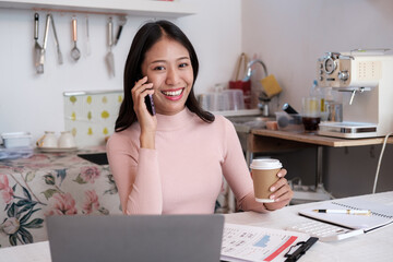 Poster - Beautiful Young Freelancer Lady Working with smartphone In Kitchen.