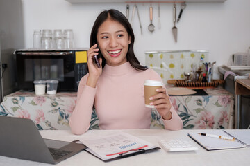 Poster - Beautiful Young Freelancer Lady Working with smartphone In Kitchen.