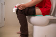 man has hemorrhoids that have worsened and enlarged, and hemorrhoids are severely inflamed, causing bleeding when defecation, infection, weakness and fainting. Inflammatory hemorrhoids pain concept