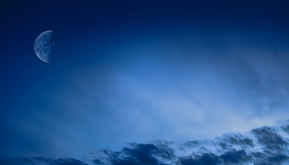 Wall Mural - Dark blue abstract background. Night sky with clouds and moonlight. Navy blue sky background with copy space for design.