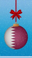 Wall Mural - Snow falling on christmas ball with flag of qatar