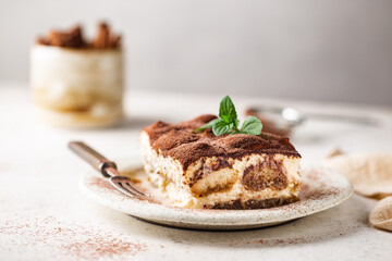 Piece of traditional Italian dessert tiramisu on white background