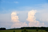 Fototapeta Tęcza - Beautiful thunderstorm landscape in the countryside. Thunderclouds and a horizon with a forest.