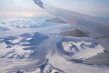 Fototapeta  - Panorama of white area of mountains and glaciers of Spitsbergen from plane. During fly to Longyearbyen, capital of Svalbard