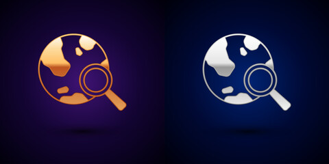 Poster - Gold and silver Magnifying glass with globe icon isolated on black background. Analyzing the world. Global search sign. Vector