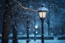 A Streetlamp Illuminating Falling Snowflakes During A Quiet Winter Evening. 