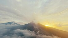 Aerial View Peaceful Gorgeous Active Erupting Volcano With Steam Crater Clouds At Sunset Sky. Wild Picturesque Nature Landscape Volcanic Mountains Valley Environmental Morning Disaster Concept Sunrise