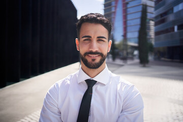 Portrait attractive young confident young business man posing outside office building. Formal professional male muslim standing positive attitude looking at camera happy expression outdoor, copy space