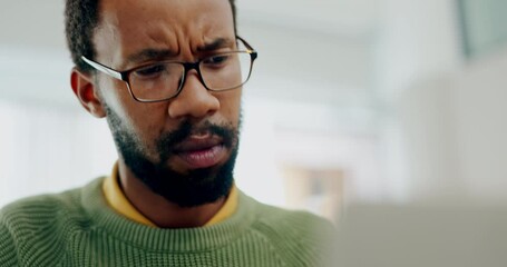 Confused, thinking and black man in the office with a laptop working on a website development. Professional, research and young African male web designer on a computer for a project at the workplace.