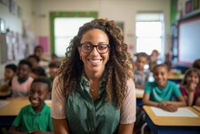 Portrait Of A Smiling Young African American Middle School Teacher Teaching A Classroom Of Students