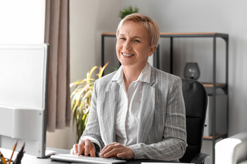 Poster - Mature businesswoman working  in office