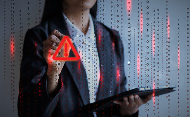 Wall Mural - Businesswoman pointing warning signs of hacking cyber triangle. Hacker attacks and hacking data, cyber crime, cyber security concept.