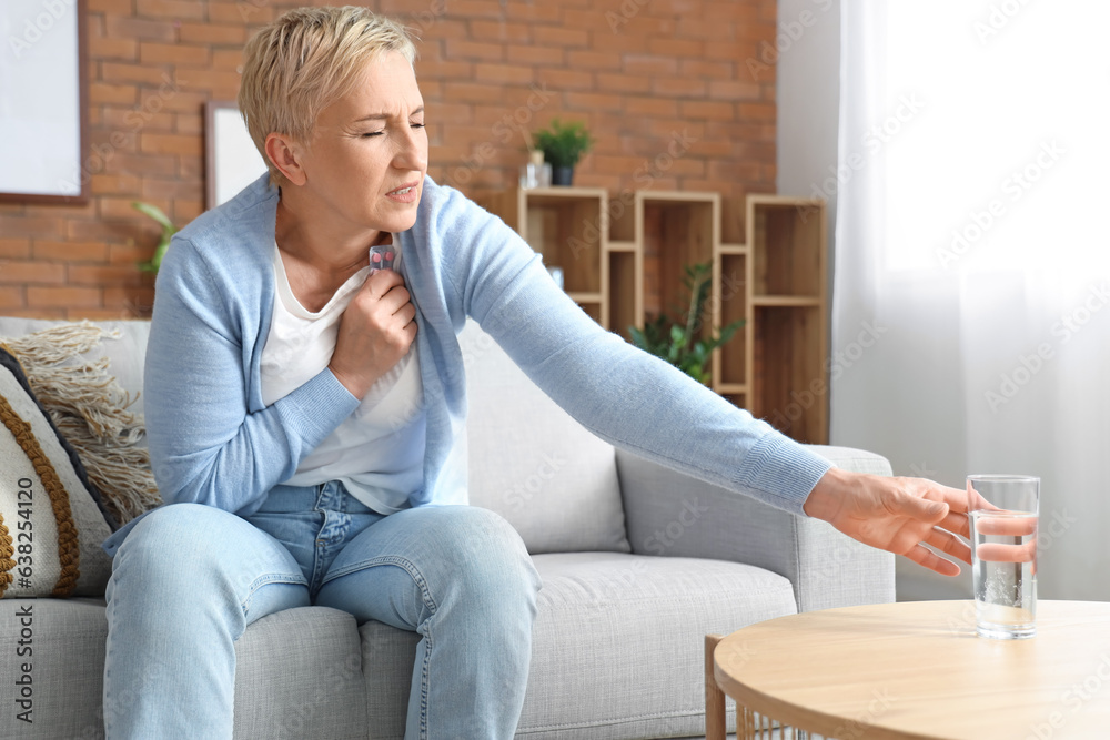 Mature woman with pills having heart attack at home