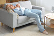© Pixel-Shot - Mature woman having heart attack on sofa at home