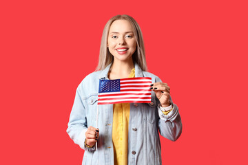 Canvas Print - Young woman with USA flag on red background