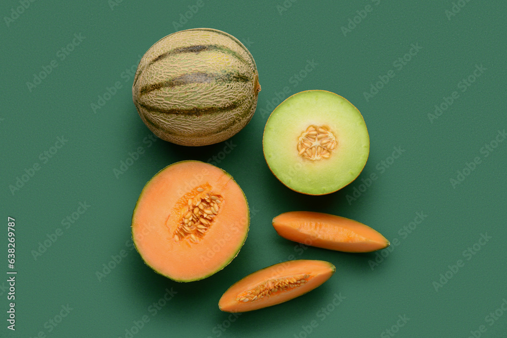 Tasty ripe melons on green background
