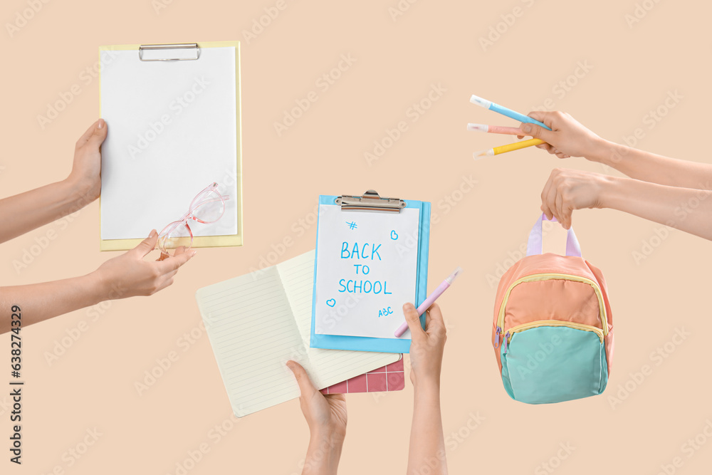 Female hands holding different stationery and notebooks with text BACK TO SCHOOL on beige background