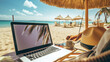 A Young woman using a laptop computer. Girl lying on the beach. Freelance girls work remotely. Freelance work. Online learning.