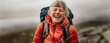 © Jacob Lund - Hiking achievement: Senior woman celebrating on a mountaintop
