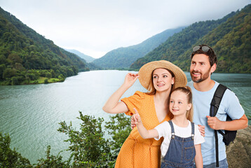 Canvas Print - Portrait of happy family with child near palm in mountains