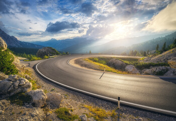 Wall Mural - mountain road at colorful sunset in summer. dolomites, italy. beautiful curved roadway, rocks, stone