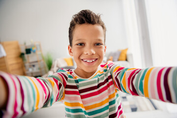 Sticker - Selfie photo of cheerful toothy smiling schoolboy recording new video his lifestyle vlogger isolated on indoors playroom background