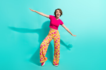 Poster - Full body porrtait of astonished positive lady arms wings flight dancing isolated on turquoise color background