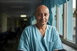 © StockImageFactory - Indian confident male cancer survivor who is bald, standing in hospital