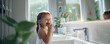 little girl brushing teeth in modern bathroom.