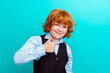 © deagreez - Photo portrait of cute curly ginger boy show thumb up symbol dressed stylish school uniform clothes isolated on cyan color background