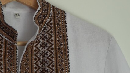 Wall Mural - Ukrainian clothes embroidered shirt. Brown beige and white black threads background. Vyshyvanka symbol of Ukraine. Embroidery cross stitching. National Ukrainian stitch. Traditional clothing