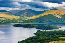 Beautiful Scottish Loch (Lake) With Islands Surrounded By Mountains And A Dramatic Sky (Loch Lomond)