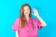 young beautiful doctor woman Waiving saying hello happy and smiling, friendly welcome gesture.