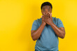 Young handsome man standing over yellow studio background shocked covering mouth with hands for mistake. Secret concept.