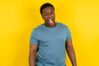Young handsome man standing over yellow studio background winking looking at the camera with sexy expression, cheerful and happy face.