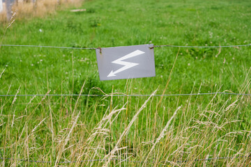 sign on grass electrify fence