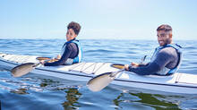 Ocean, Portrait Of Happy Man And Woman In Kayak At Lake, Beach Or River For Exercise Challenge. Sports Holiday, Adventure And Fitness, Couple Rowing In Canoe For Training Workout And Fun Race At Sea.