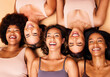 © Anela/peopleimages.com - Diversity, beauty and portrait of women from above with smile, self love and solidarity in studio. Happy face, group of friends on beige background with underwear, skincare and cosmetics on floor.