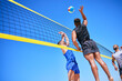 © LuneVA/peopleimages.com - Beach volleyball match, blue sky and sports team jump, playing competition and practice for tournament challenge. Below view, athlete action and people in air workout, training or nature exercise
